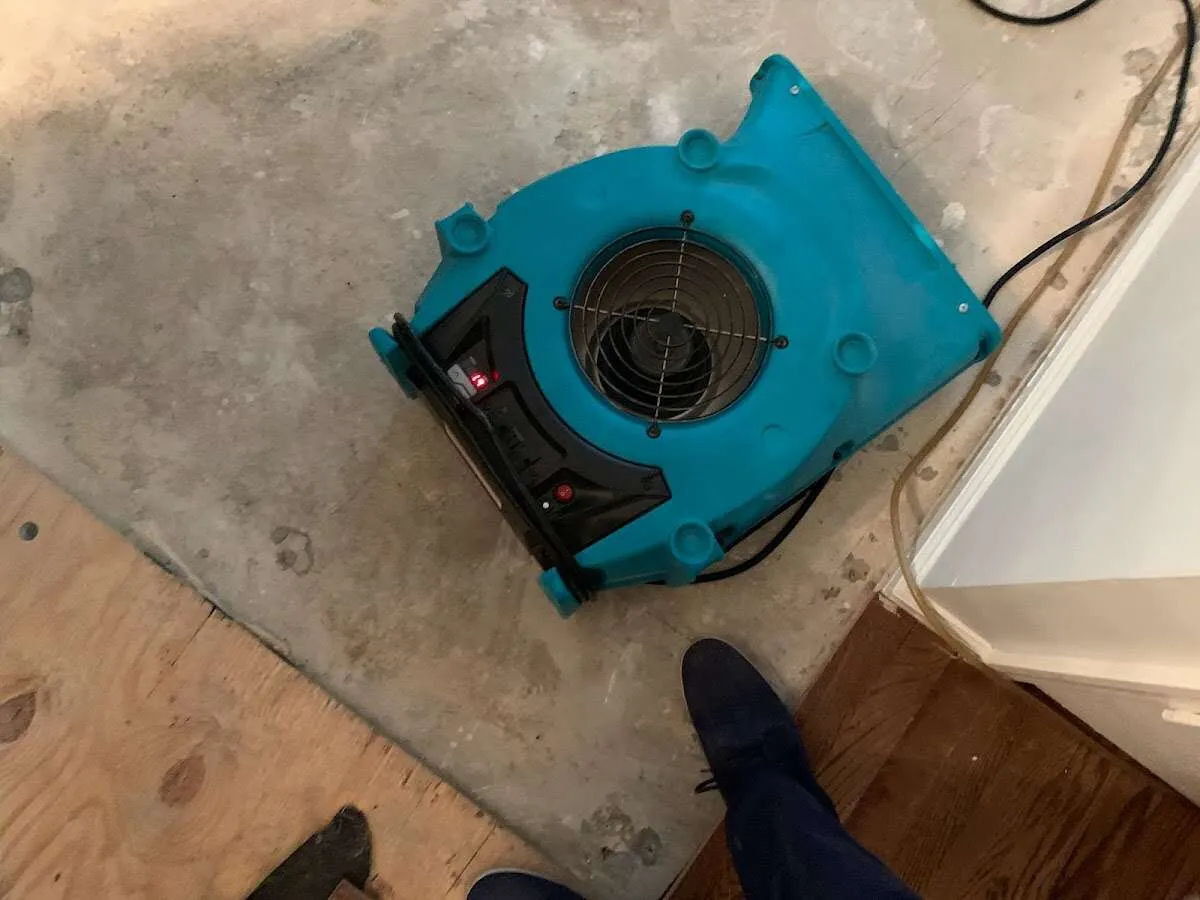 Air mover drying subfloor during Commercial Water Damage Restoration in Downingtown